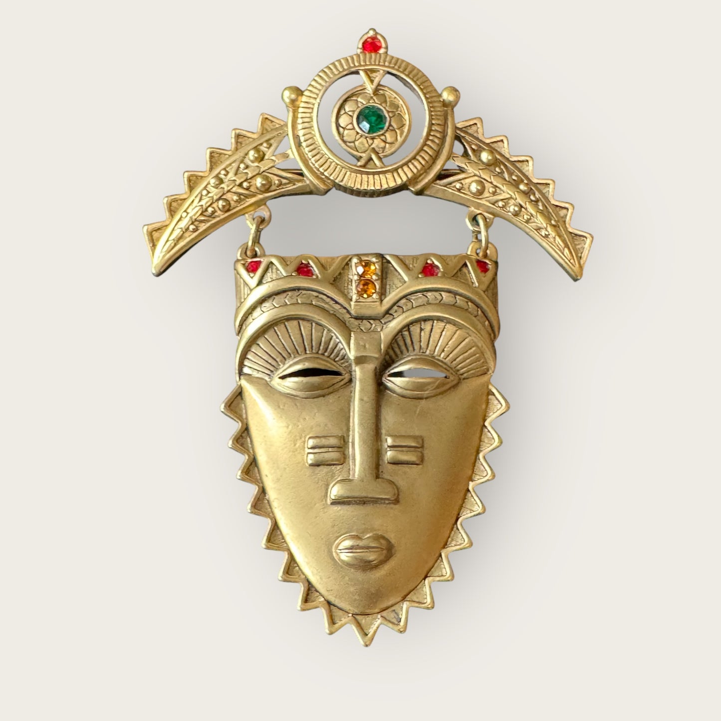 Vintage Avon Articulated Tribal Mask Brooch – Matte Gold with Red, Green & Orange Rhinestones, Signed