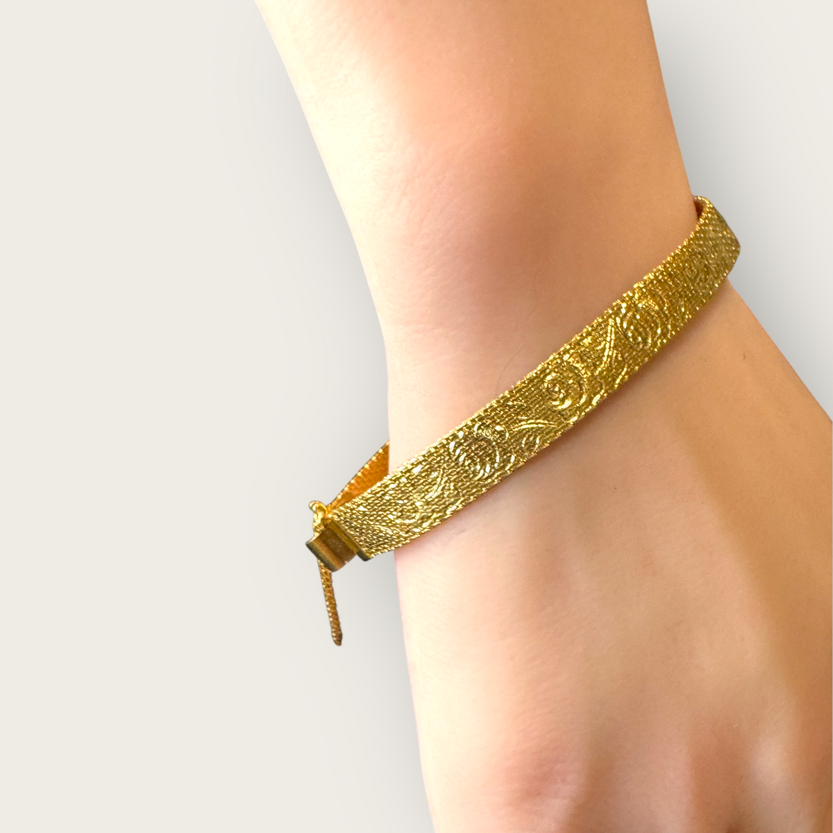 Vintage 1950s Monet Gold-Tone Rose Embossed Bracelet with Safety Chain – Signed Mid-Century Elegance