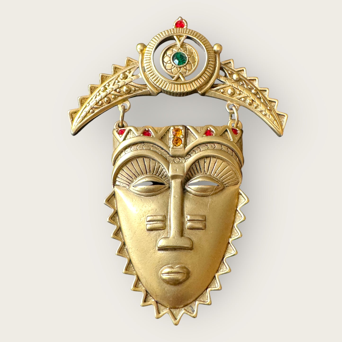 Vintage Avon Articulated Tribal Mask Brooch – Matte Gold with Red, Green & Orange Rhinestones, Signed