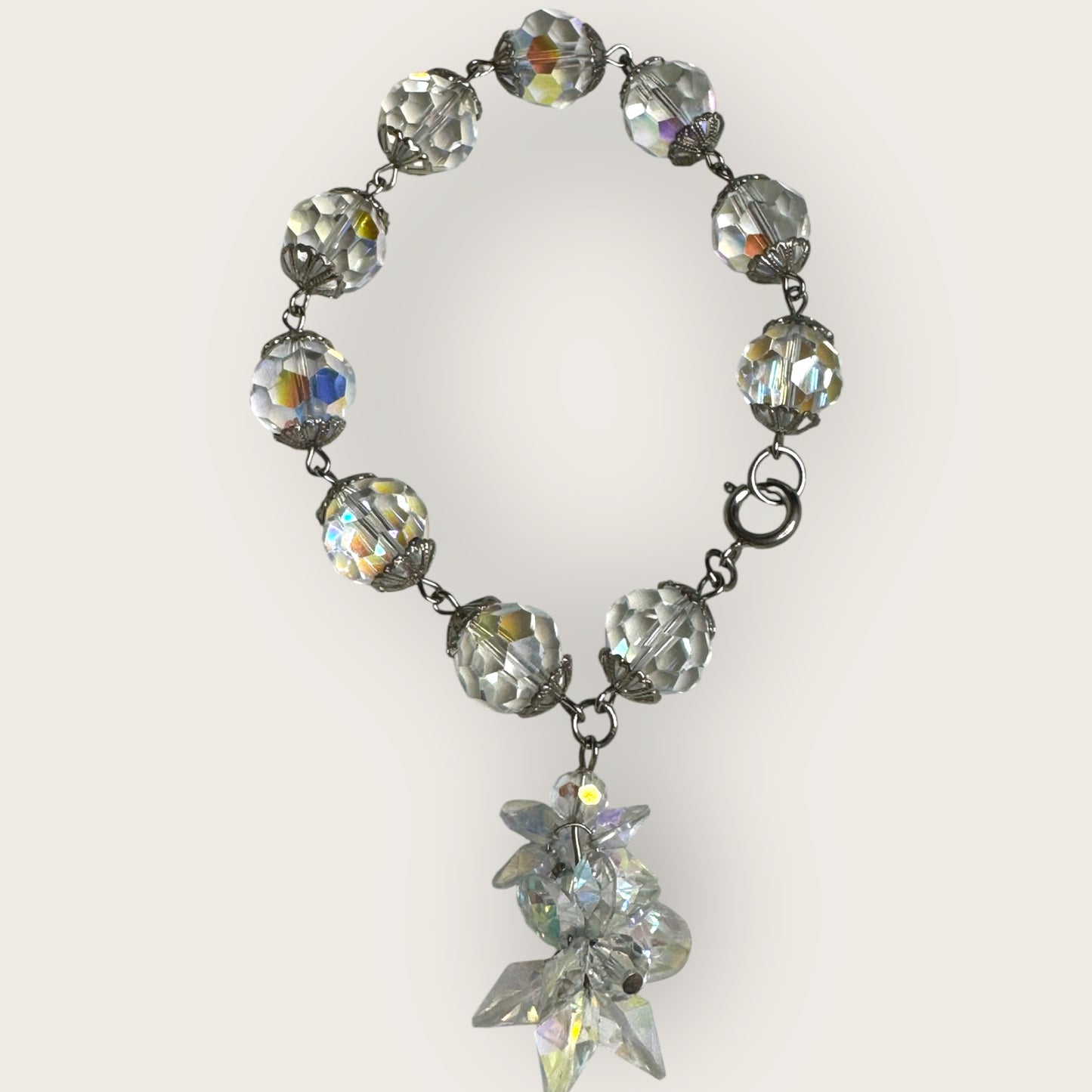 Vintage aurora borealis crystal bracelet with silver filigree spacers and dangle, 1950s