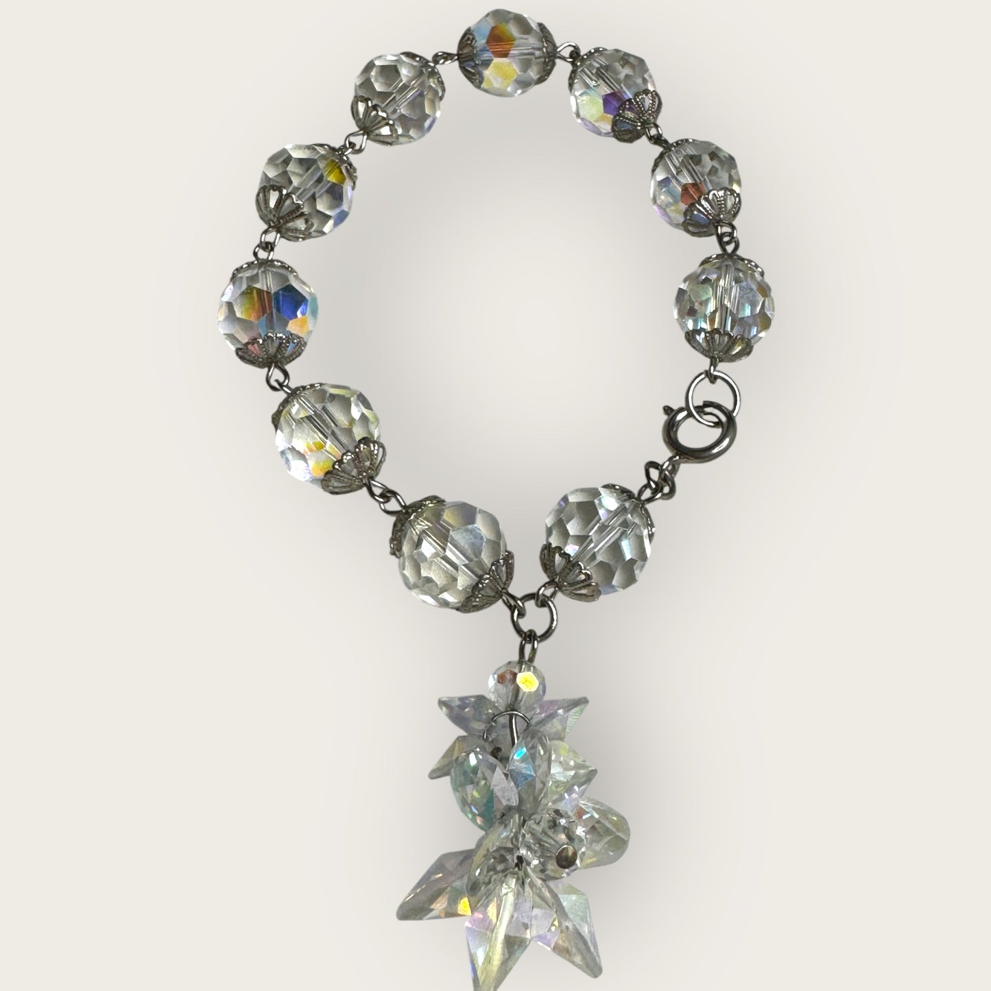 Vintage aurora borealis crystal bracelet with silver filigree spacers and dangle, 1950s