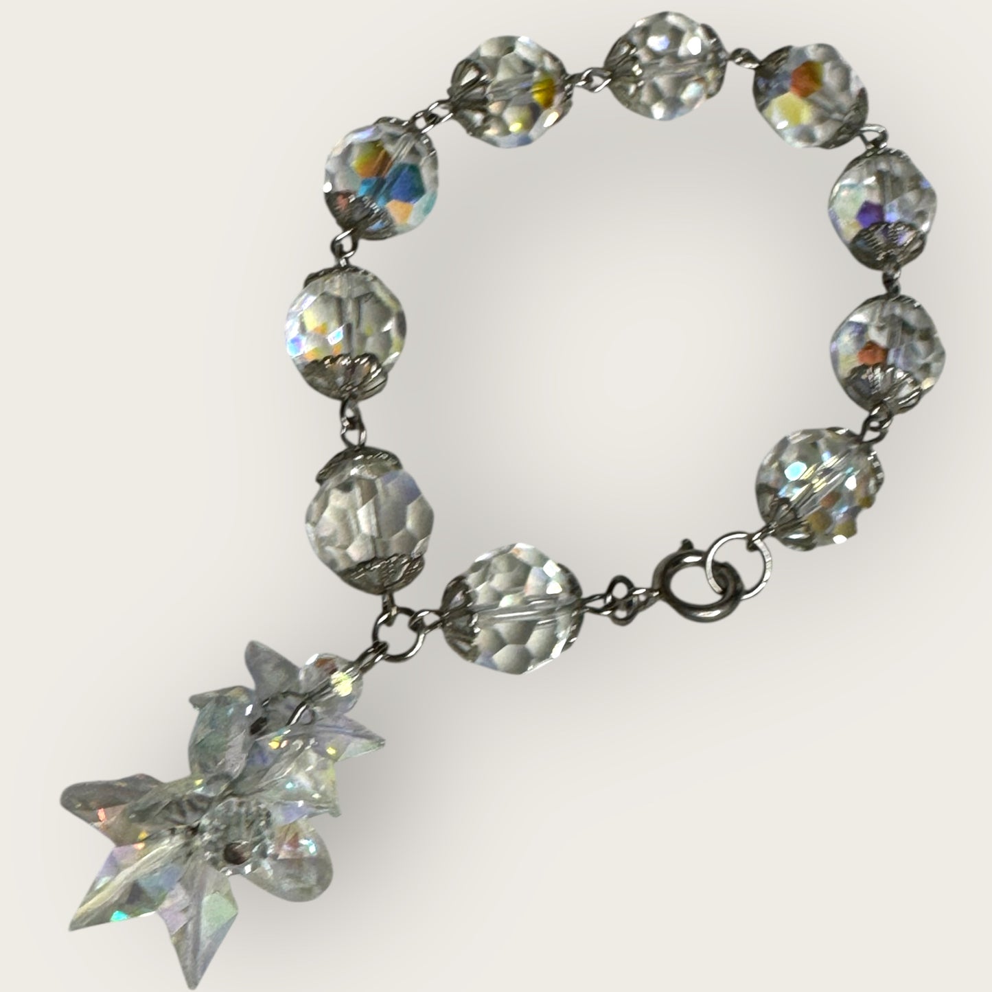 Vintage aurora borealis crystal bracelet with silver filigree spacers and dangle, 1950s
