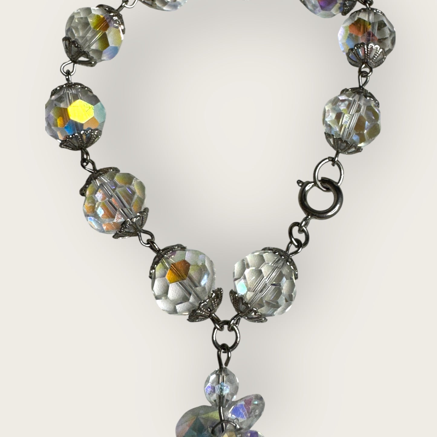 Vintage aurora borealis crystal bracelet with silver filigree spacers and dangle, 1950s