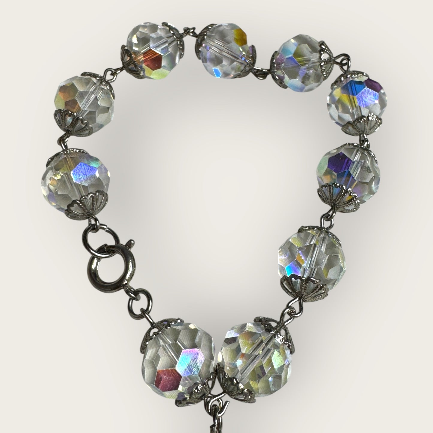 Vintage aurora borealis crystal bracelet with silver filigree spacers and dangle, 1950s