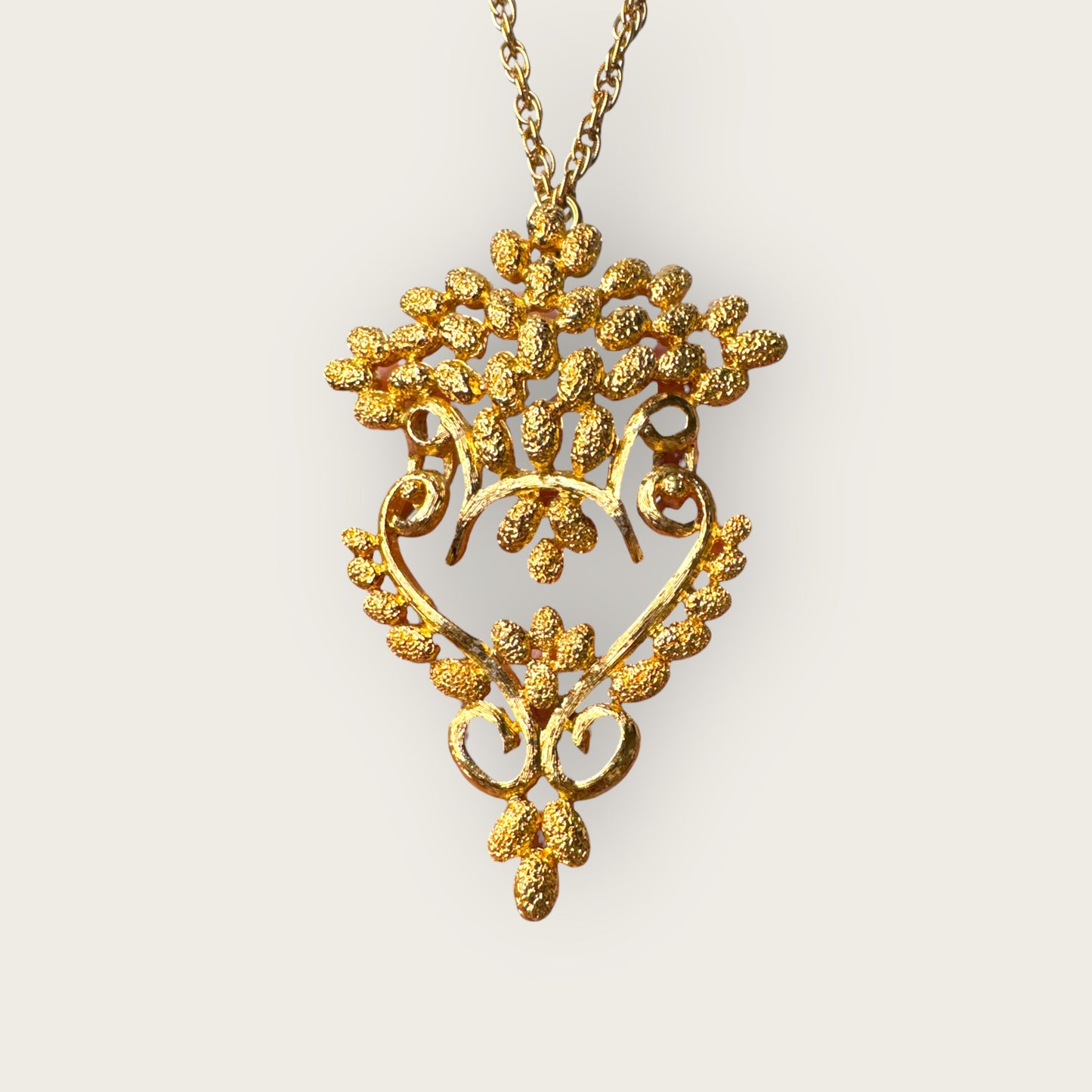 Vintage 1975 Monet “Felice” Statement Pendant Necklace – Gold-Tone Textured Scrollwork | Book Piece