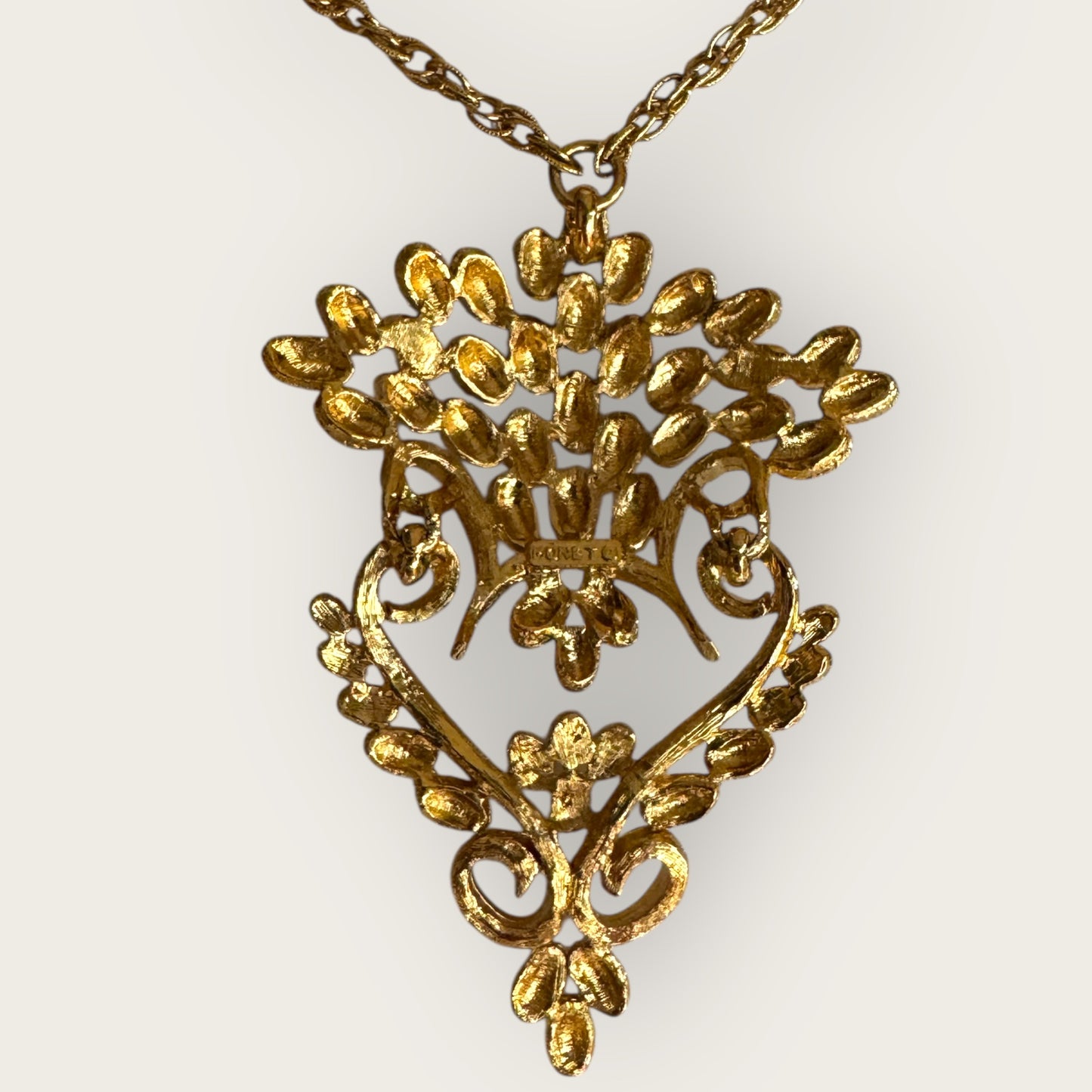 Vintage 1975 Monet “Felice” Statement Pendant Necklace – Gold-Tone Textured Scrollwork | Book Piece