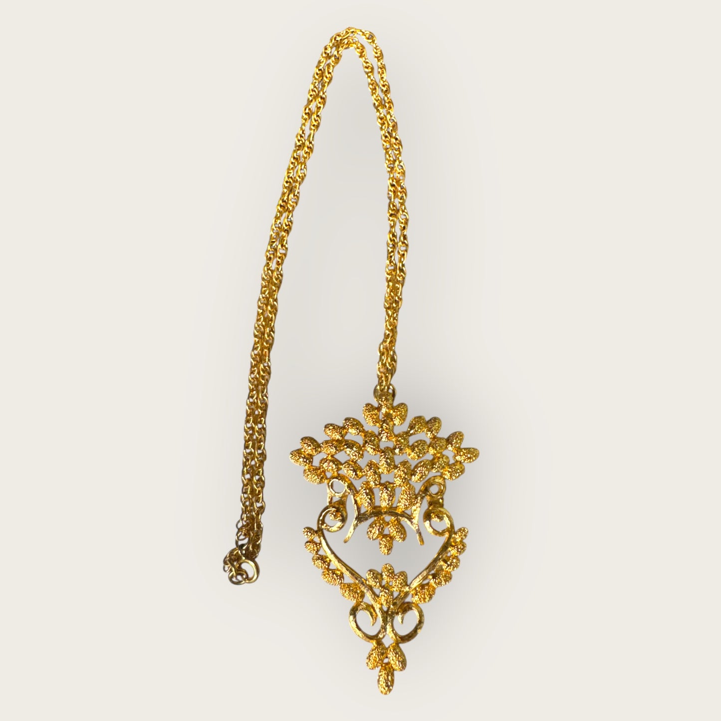 Vintage 1975 Monet “Felice” Statement Pendant Necklace – Gold-Tone Textured Scrollwork | Book Piece