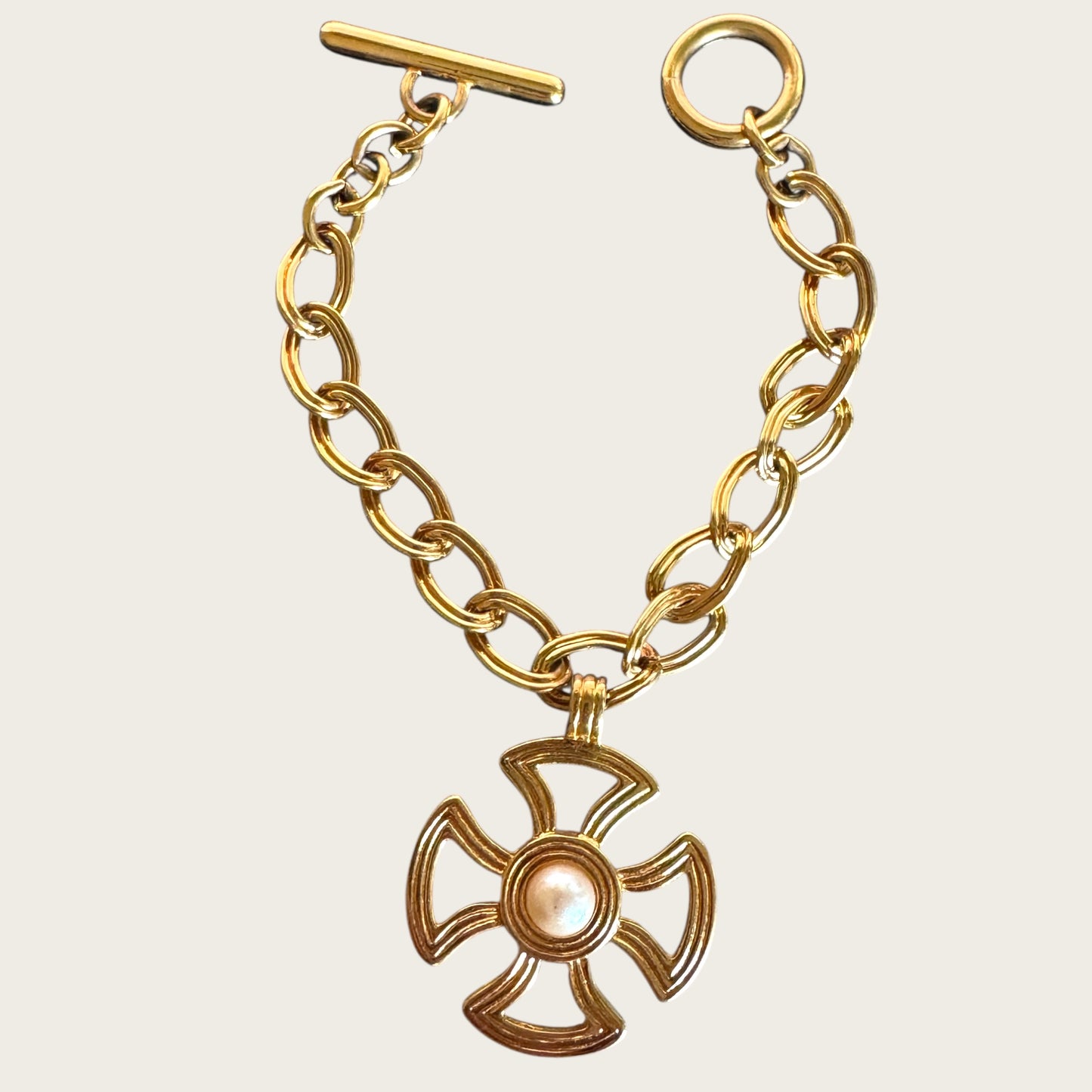 Vintage Monet Gold Tone Toggle Necklace with Sculptural Cross Medallion