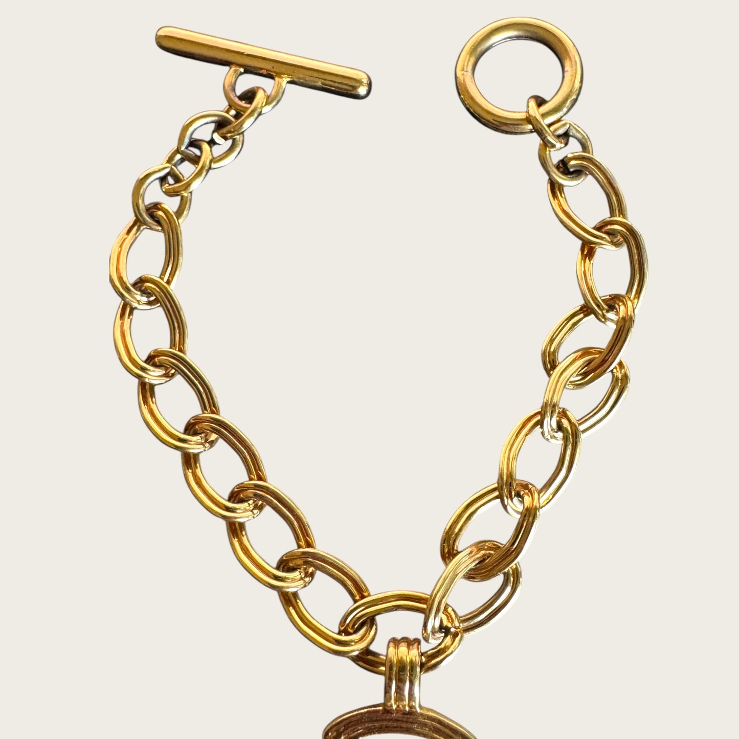 Vintage Monet Gold Tone Toggle Necklace with Sculptural Cross Medallion
