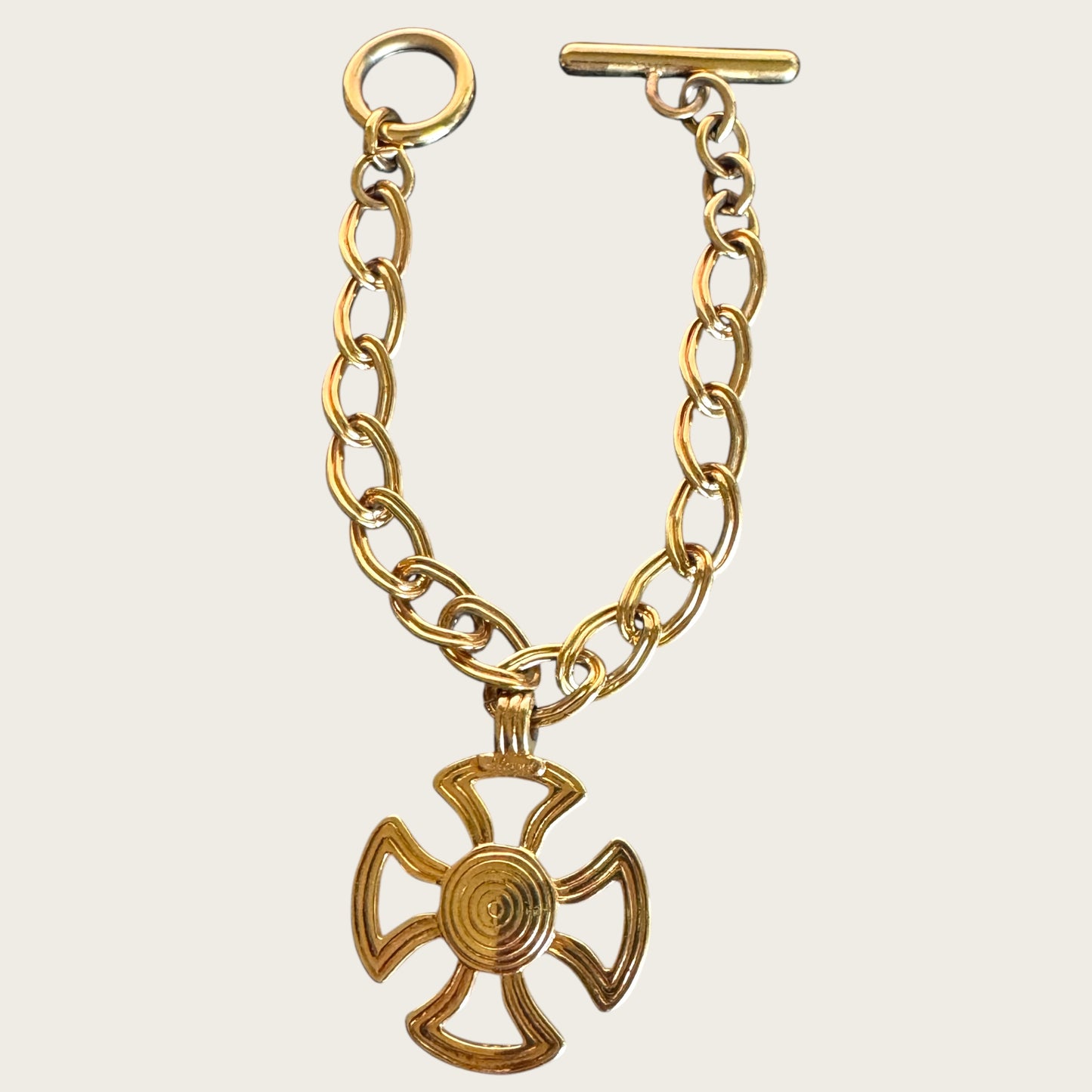 Vintage Monet Gold Tone Toggle Necklace with Sculptural Cross Medallion